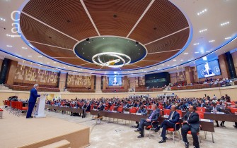 U.S. Secretary of State John Kerry delivering address inside auditorium (wikimedia commons)