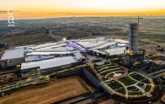 Night time aerial view of completed structure showing courtyard, skylight structure and PwC tower in background (mdsarch.co.za)