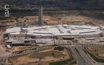 Frontal aerial view of construction site showing mall structure in place and access roads (businesstech.co.za)