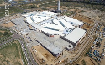 Aerial view showing mall roof and skylight facade completed, ongoing carpark construction and PwC tower under construction in background (mallofafrica.co.za)